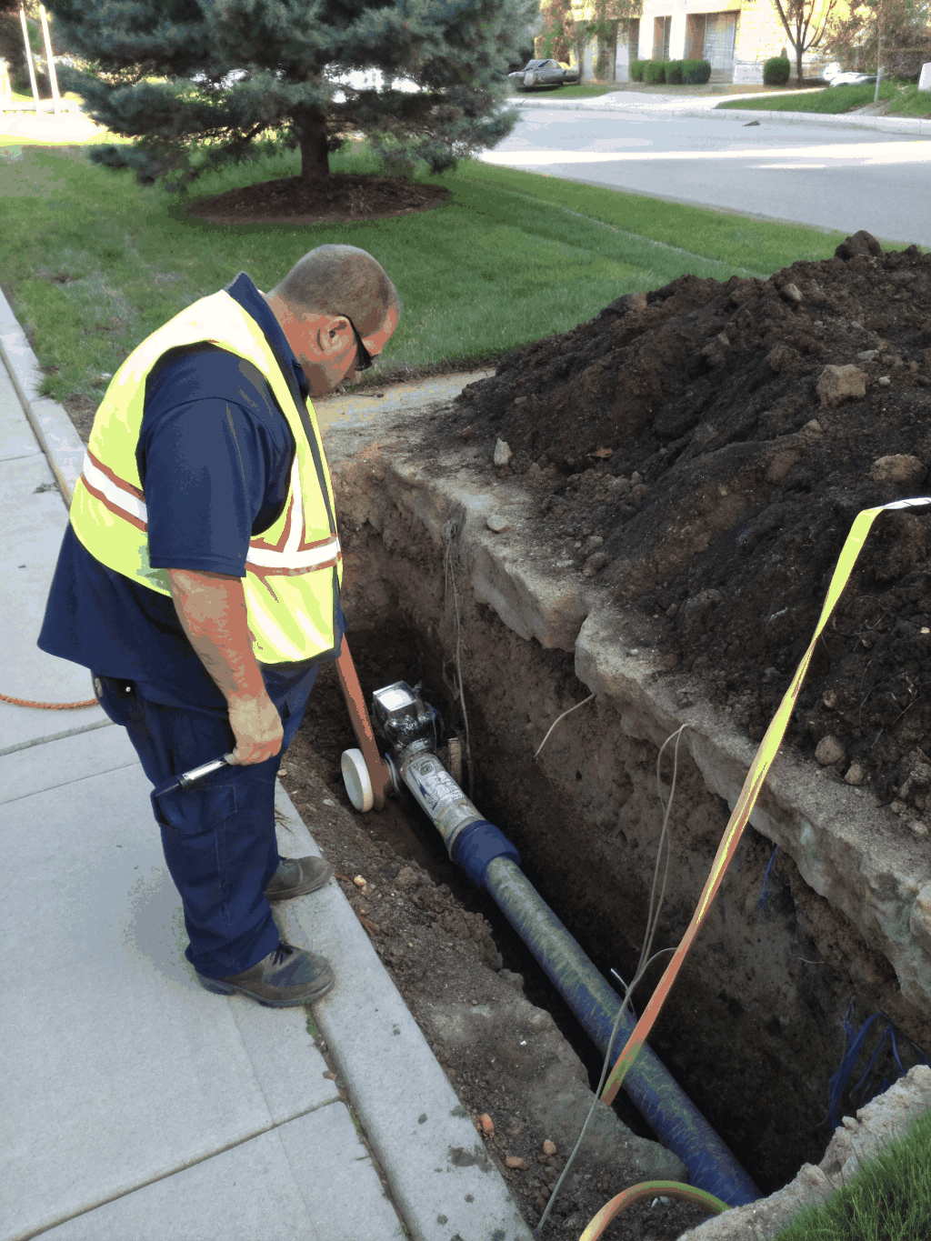Technician performing a sewer camera inspection to locate a pipe break